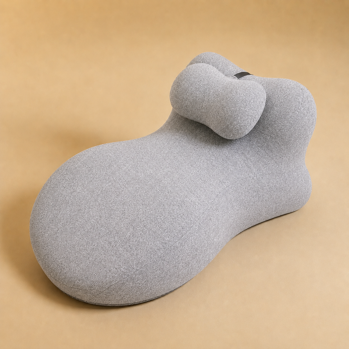 The Amoret Pillow Pro in dove grey on a soft sand backdrop