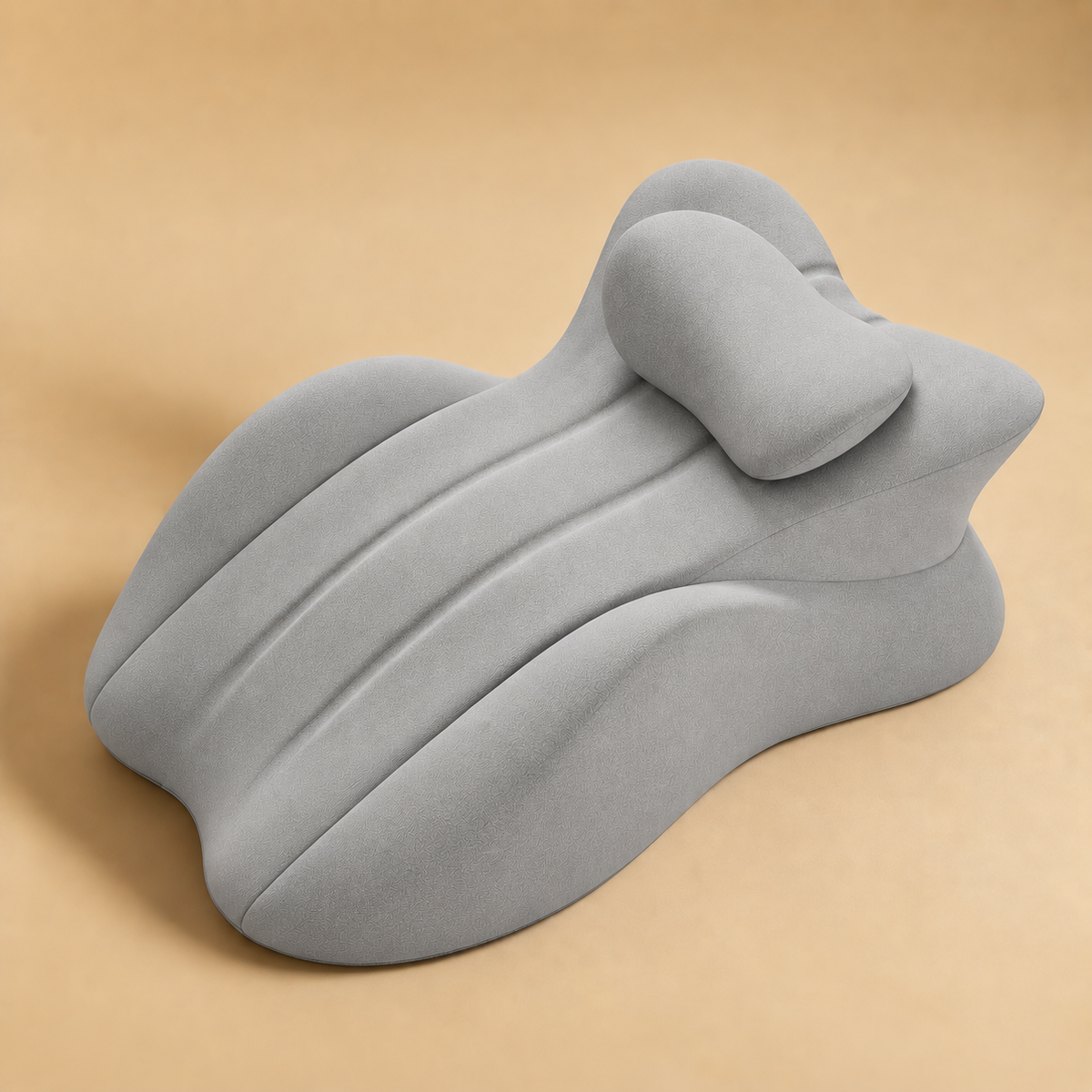 The Amoret Pillow in dove grey on a soft sand backdrop