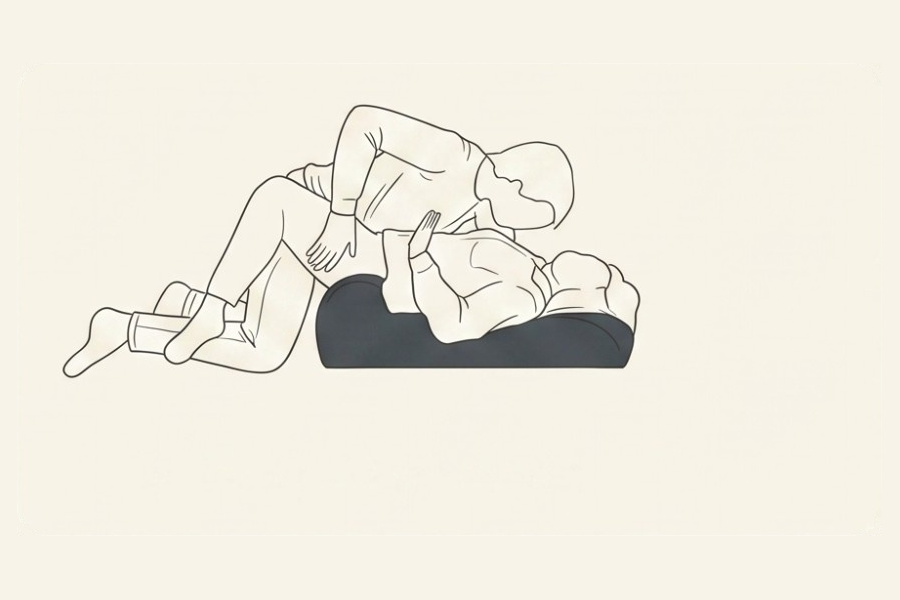 Line drawing: a couple using the Amoret pillow, position 3 of 6, from the Four-Sunday Sex Reset